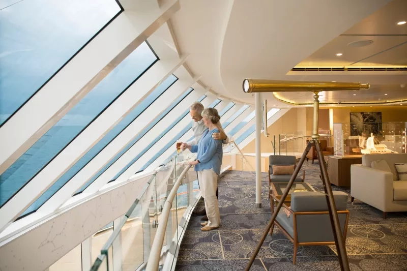 Couple looking out windows of the Explorer's Lounge