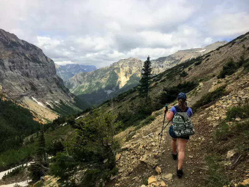 Hiking the rocky terrain of the Crypt Lake Trail, a steep ascent to Crypt Lake including walking a long the very edge of a mountain.  The hike is in Waterton Lakes National Park in Alberta, Canada