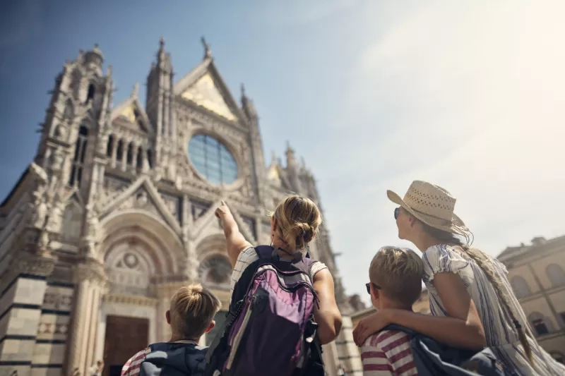 Mother and kids sightseeing city of Siena, Tuscany, Italy