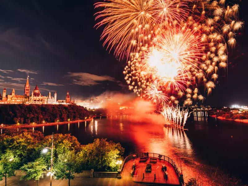 Canadian Parliament on Ottawa River with fireworks