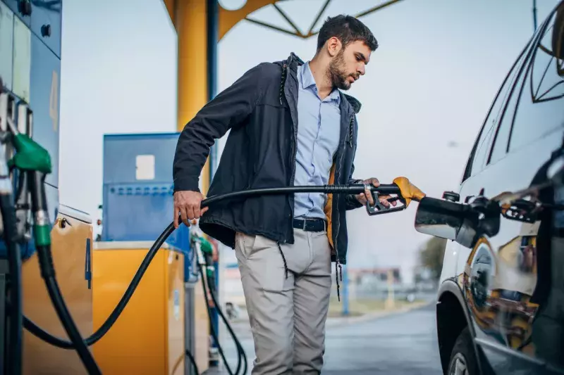 Guy pouring fuel in vehicle at the gas station