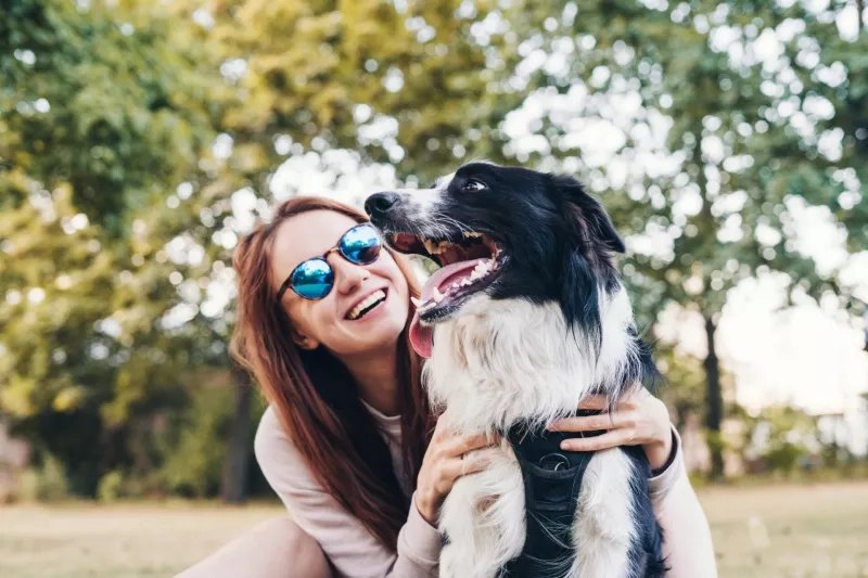 Young woman playing with a dog outdoors