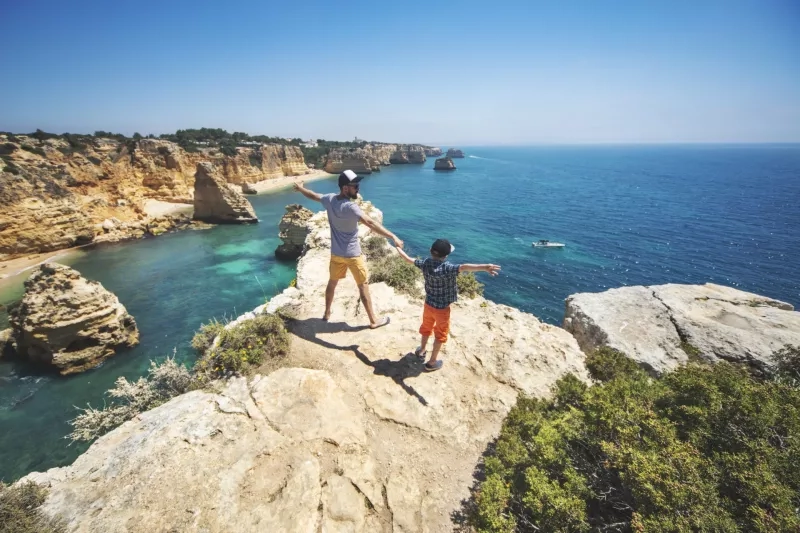 Father and son walking at the beach