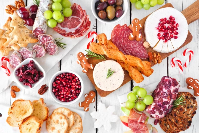 Christmas theme charcuterie table scene against white wood