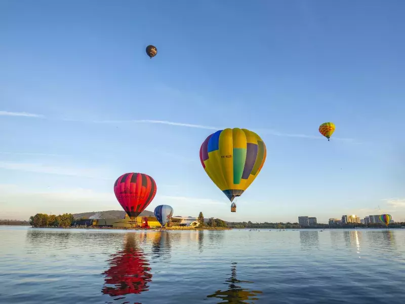 Colorful hot air balloons floating over Lake Burley Griffin in Canberra, Australia