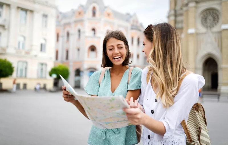 Happy friends enjoying sightseeing tour in the city.