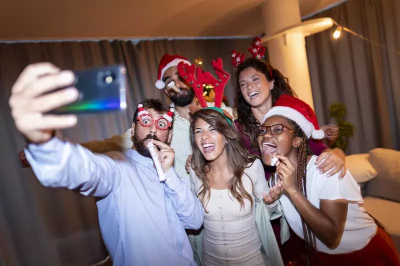 Friends taking a selfie at New Year's Eve midnight countdown