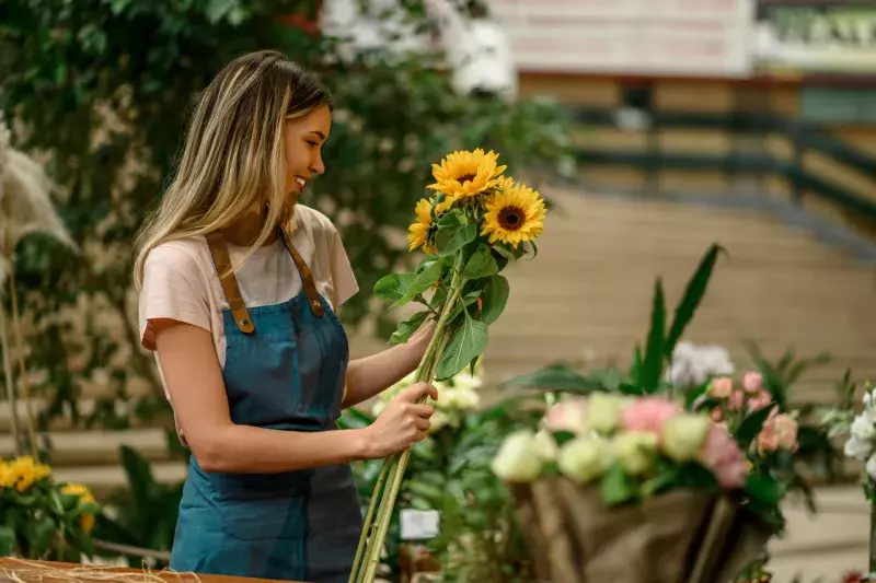 Florist woman making a bouquet of fresh flowers in a flower shop