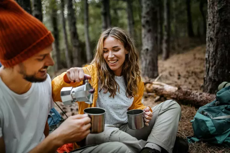 Young women serving coffee during hiking