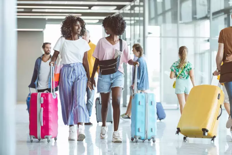 Passengers walking with luggage at airport