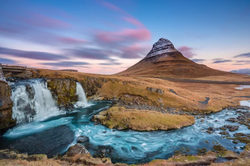 Breathtaking landscape with waterfall near Kirkjufellsfoss and Kirkjufell hills in Iceland