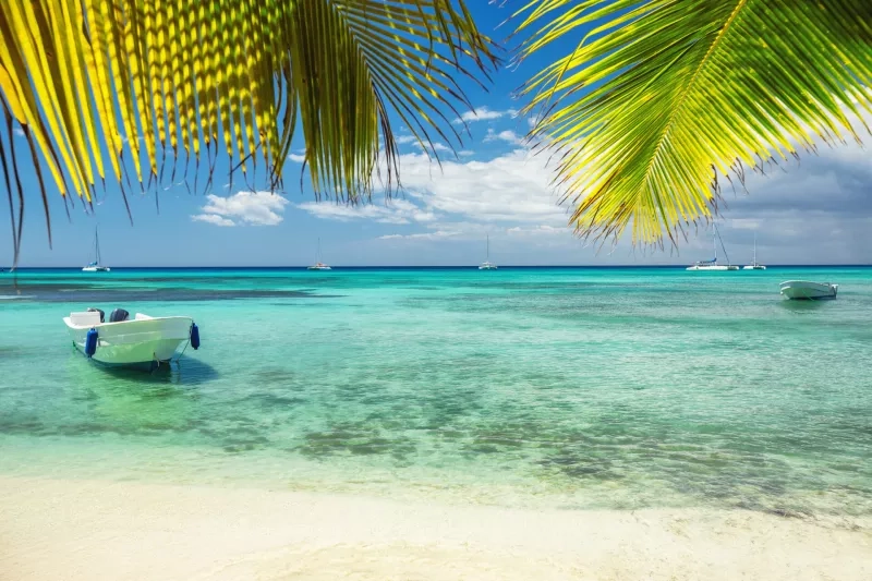 boat on the shore of exotic tropical island, panoramic view from the beach