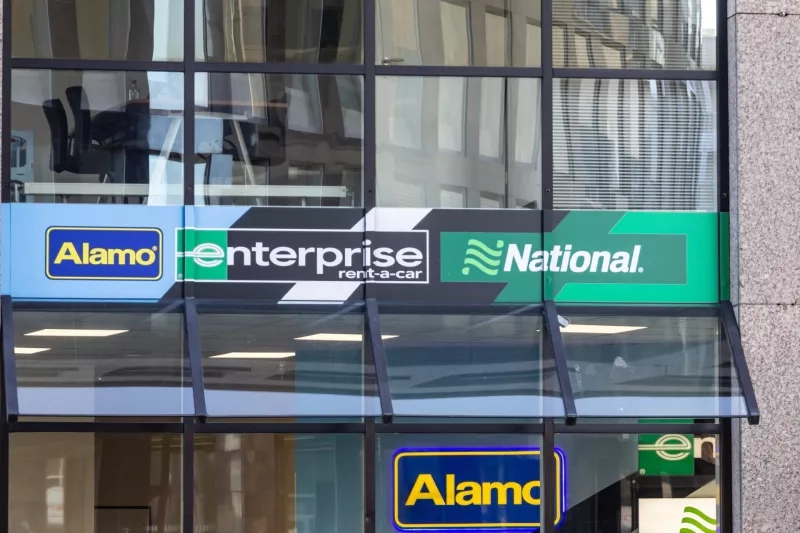 Logos of the companies of Enterprise Holdings, a group of car rental companies, showing the logos of Alamo, Enterprise rent a car and National Car Rental.