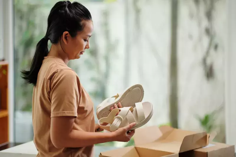 Woman Unpacking Faux Leather Sandals