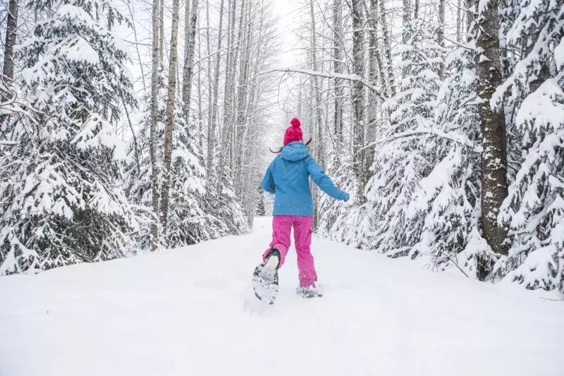 Portrait of young woman in winter snow.