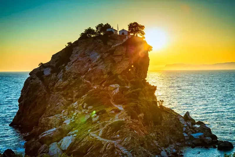 Rock with Agios Ioannis church on Skopelos island at sunrise