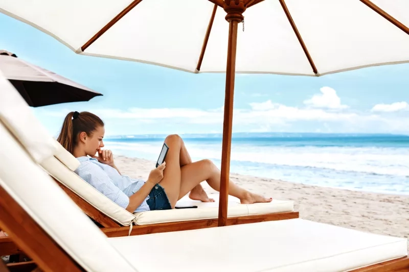 Summer Relaxation. Woman Reading, Relaxing On Beach. Summertime