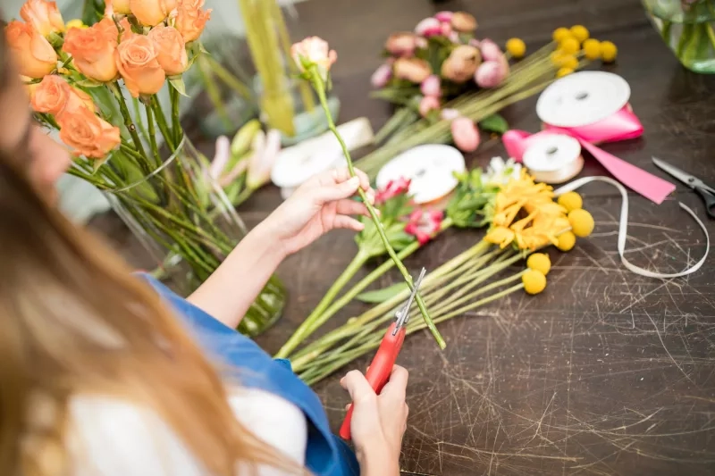 Woman cutting flower stems