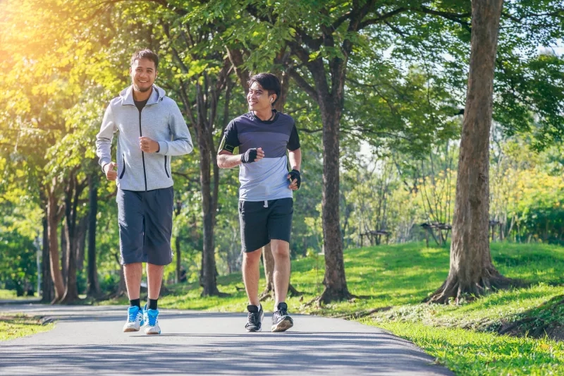 Two young men running in the park, fitness sport and lifestyle concept