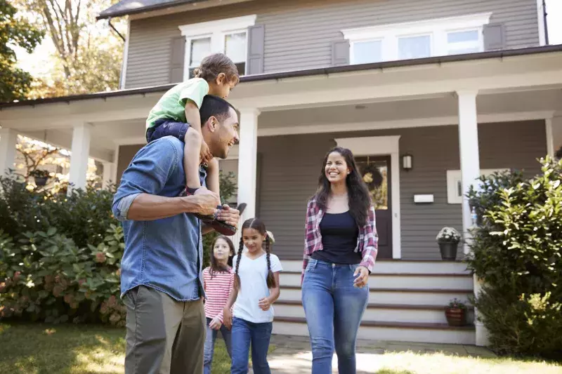 Father Gives Son Ride On Shoulders As Family Leave House